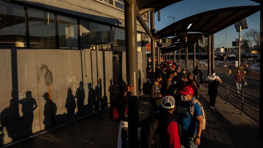 Pedestrians wait to cross the San Ysidro Port of Entry border crossing bridge in Tijuana, Mexico, on Wednesday, March 23, 2022.