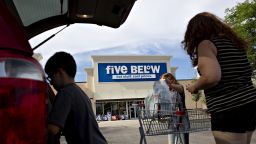 Shoppers place purchases into vehicle outside a Five Below Inc. store in Bloomington, Illinois, U.S., on Wednesday, July 25, 2018.