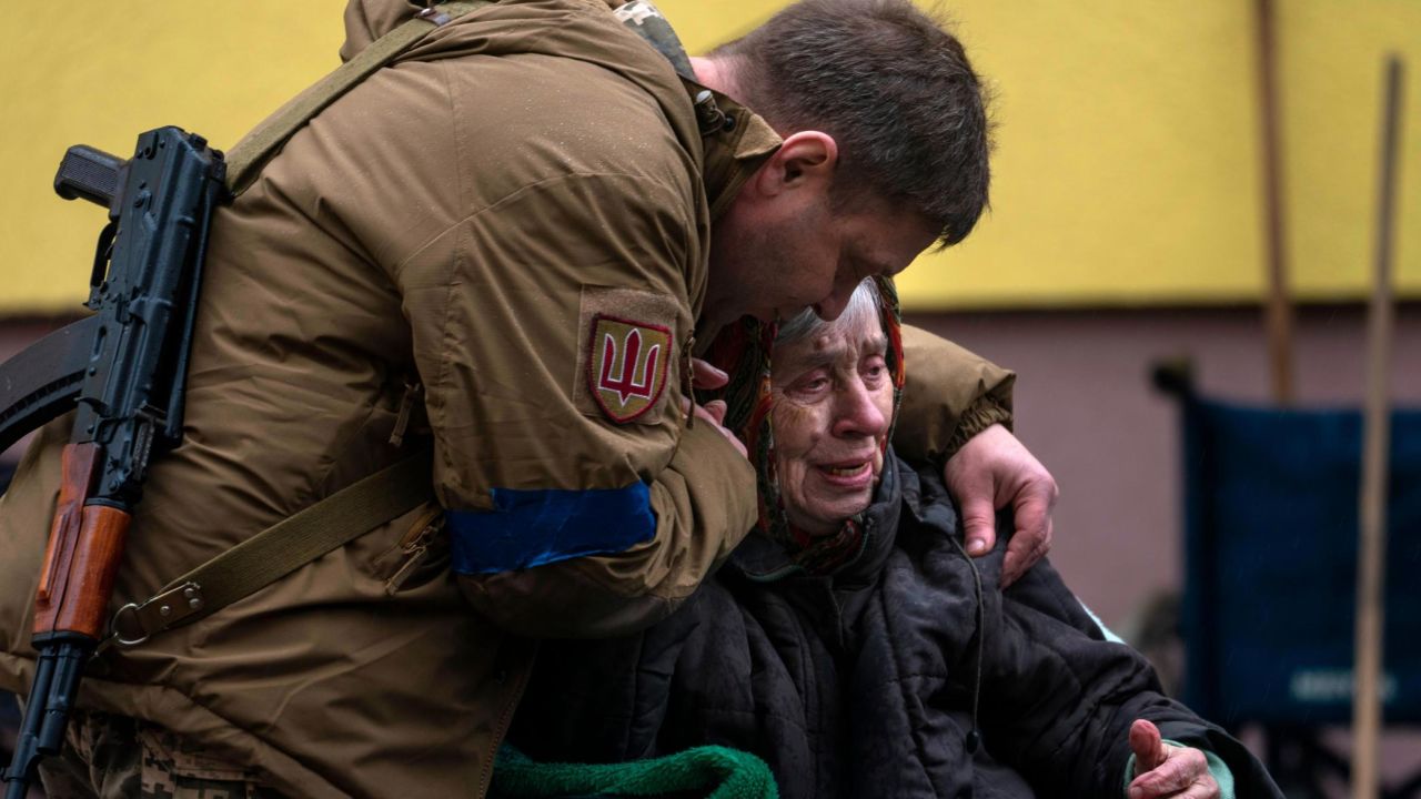 A soldier comforts Larysa Kolesnyk, 82, after being evacuated from Irpin, on the outskirts of Kyiv, on March 30, 2022.
