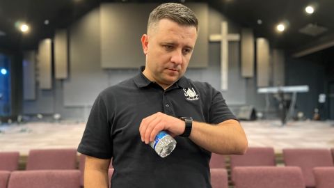 Senior Pastor Vadym Dashkevych taking a call in Sacramento on his watch from a contact at the Mexican border.
