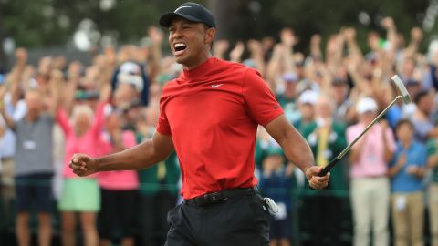 Woods celebrates on the 18th green after winning the 2019 Masters.