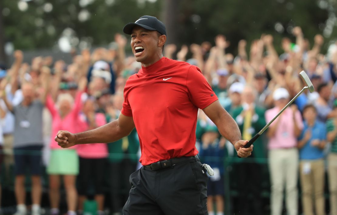 Woods celebrates on the 18th green after winning the 2019 Masters.
