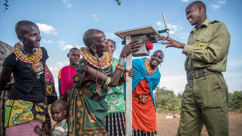 Lion Landscapes also provides technology to improve the safety of tribal communities as lion populations recover. Here, a conservation officer shows the workings of an alarm to be fixed to a boma, a traditional fortified fence.