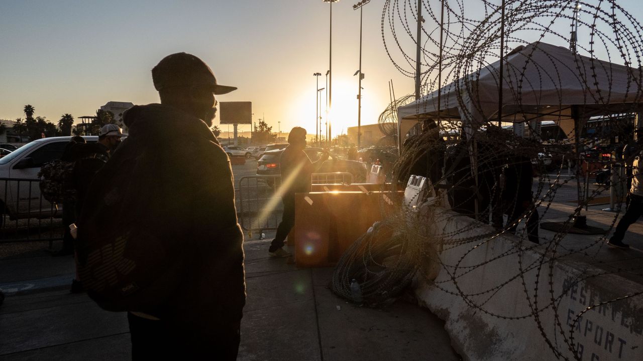 A migrant from Haiti stands near a border crossing bridge in Tijuana, Mexico, on March 22.