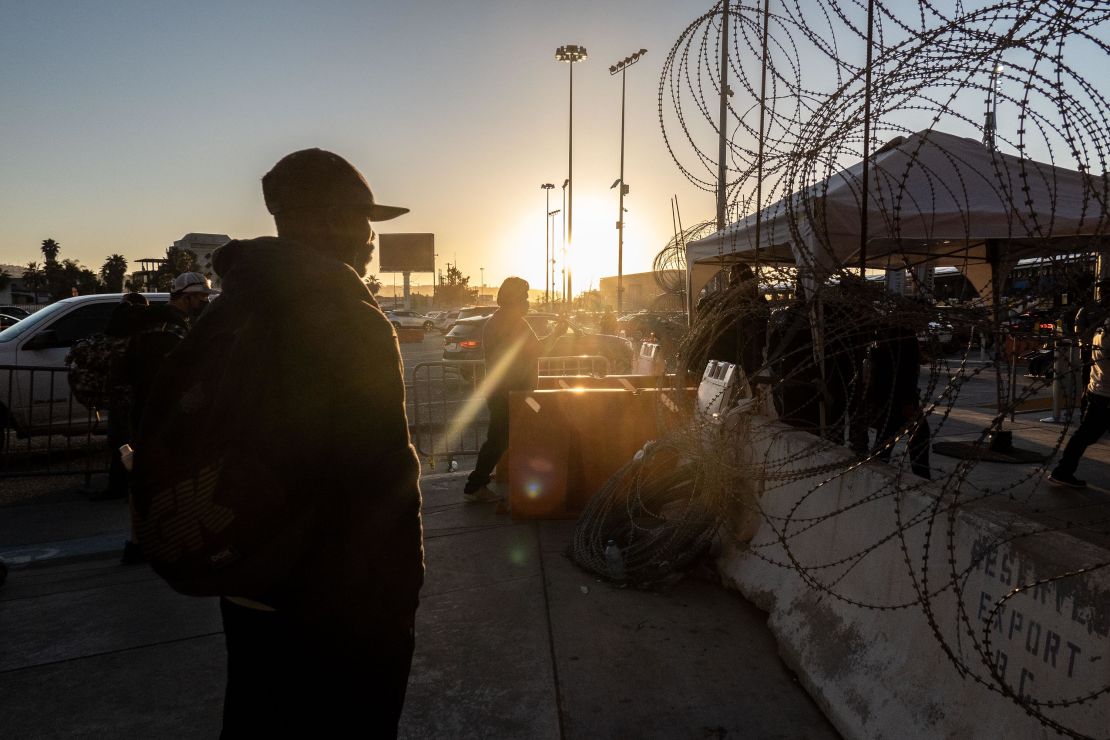 A migrant from Haiti stands near a border crossing bridge in Tijuana, Mexico, on March 22.