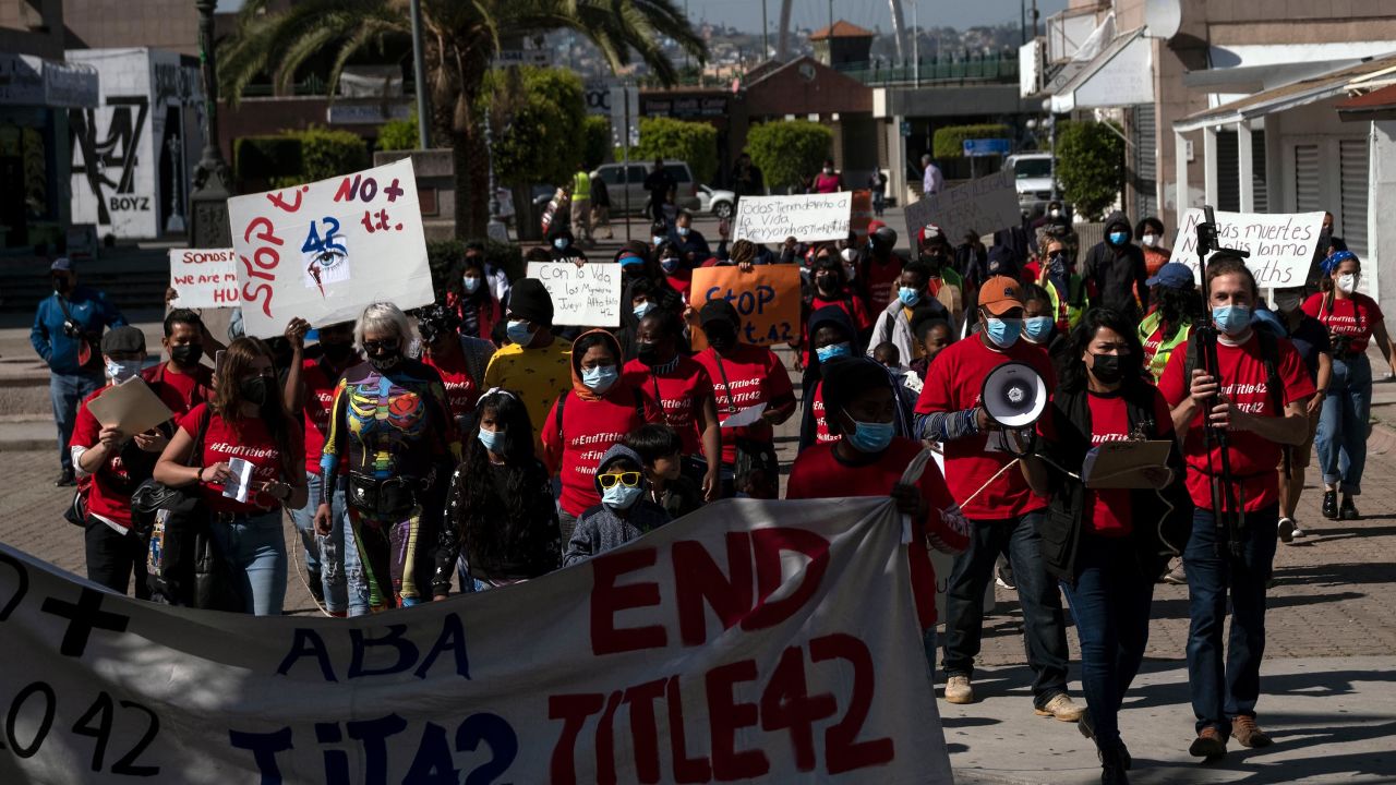 Migrants and asylum seekers march to protest against Title 42 policy heading to the Mexican side of the San Ysidro Crossing port in Tijuana, Baja California state, Mexico, on March 21, 2022. Title 42 is a policy from Donald Trump's administration that stopped most arrivals at the southern border on the grounds that migrants could spread Covid-19.