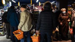 Residents shopping for food and supplies queue at the checkout area of a supermarket in Kyiv, Ukraine, on Tuesday, March 1, 2022. 