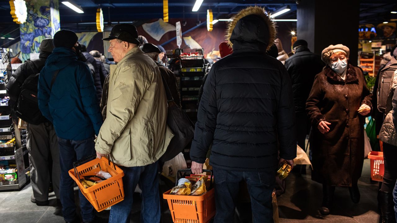 Residents shopping for food and supplies queue at the checkout area of a supermarket in Kyiv, Ukraine, on Tuesday, March 1, 2022.