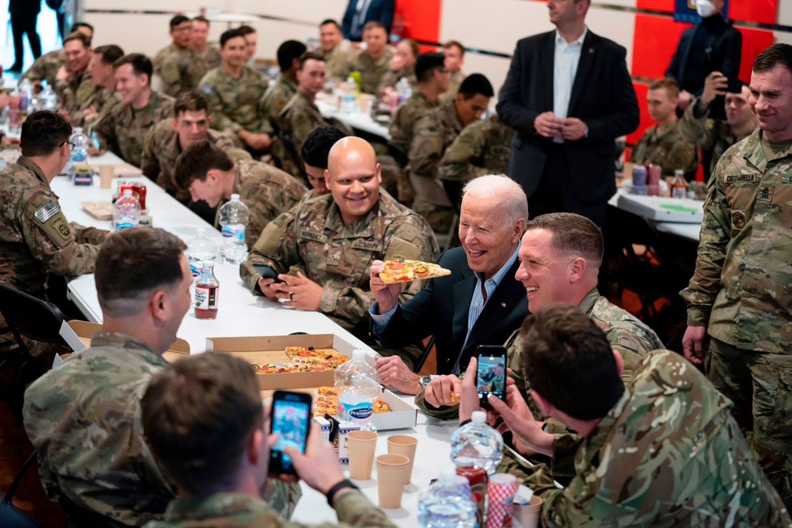 US President Joe Biden eats a slice of pizza while visiting US service members stationed in Poland on Friday, March 25. <a href="index.php?page=&url=https%3A%2F%2Fwww.cnn.com%2F2022%2F03%2F24%2Fpolitics%2Fgallery%2Fbiden-trip-belgium-poland%2Findex.html" target="_blank">Biden was in Europe</a> to attend a series of last-minute summits regarding Russia's invasion of Ukraine.