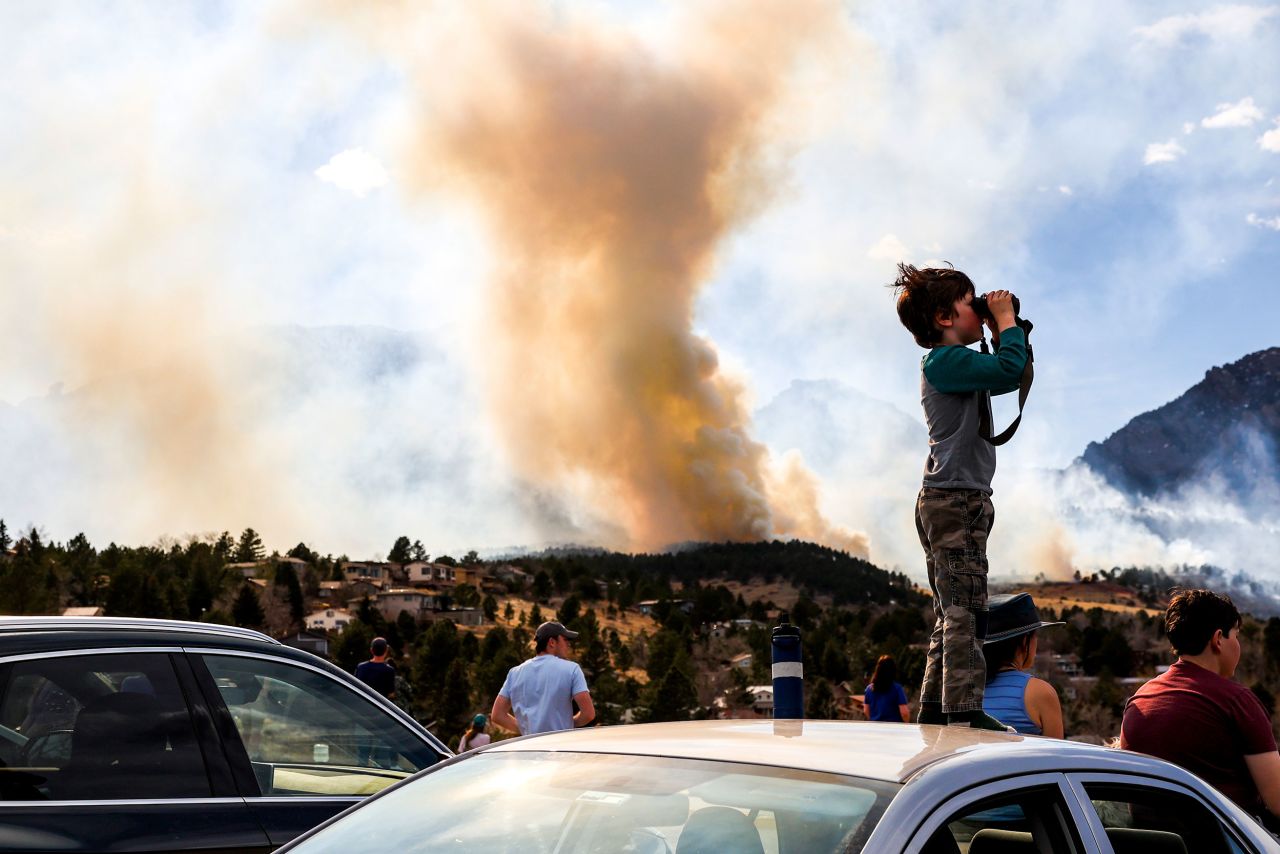 Amitai Beh, 6, watches the NCAR Fire through binoculars in Boulder, Colorado, on Saturday, March 26. <a href="https://www.cnn.com/2022/03/28/us/boulder-colorado-wildfire-monday/index.html" target="_blank">The wildfire</a> forced 19,000 residents to evacuate their homes. <a href="http://www.cnn.com/2022/03/29/photos/gallery/western-wildfires/index.html" target="_blank">See more photos of wildfires in Colorado and Texas.</a>