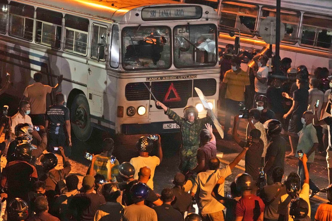 A Sri Lankan policeman tries to disperse protesters outside the President's home on March 31, 2022. 