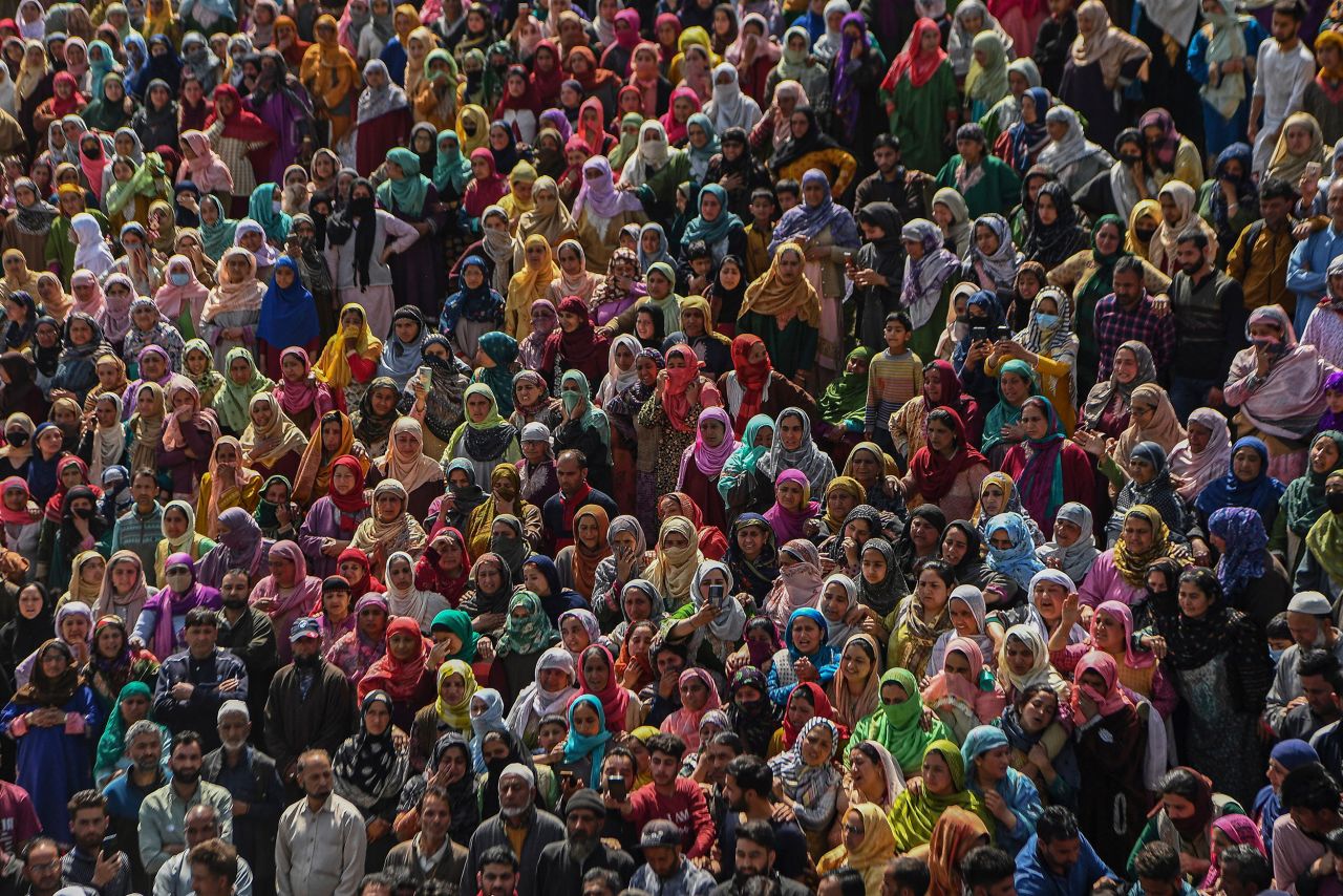 People attend the funeral of police officer Ishfaq Ahmad and his brother, Umar Jan, who were <a href="https://kashmirreader.com/2022/03/28/hundreds-attend-funeral-prayers-of-slain-cop-his-brother-in-budgam/" target="_blank" target="_blank">fatally shot at their house</a> in the Budgam district of Indian-controlled Kashmir on Saturday, March 26.