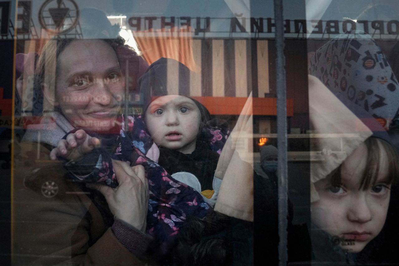 People look out from a bus at a refugee center in Zaporizhia, Ukraine, on Friday, March 25. More than 4 million refugees have fled Ukraine to neighboring countries, according to the United Nations' refugee agency.