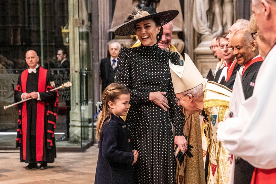 The Duchess of Cambridge reacts as she introduces her daughter, Princess Charlotte, to the Archbishop of Canterbury ahead of the service.