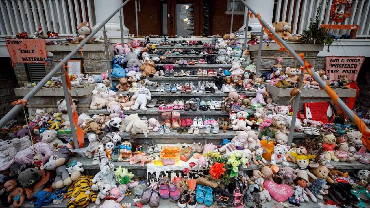 Children's shoes and stuffed animals sit on the steps as a tribute to the missing children of the former Mohawk Institute Residential School in Brantford, Canada, last November. Crews were searching for more unmarked graves of students near Toronto. 