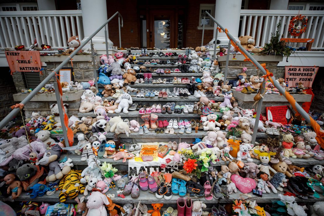 Children's shoes and stuffed animals sit on the steps as a tribute to the missing children of the former Mohawk Institute Residential School in Brantford, Canada, last November. Crews were searching for more unmarked graves of students near Toronto. 