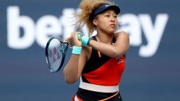 MIAMI GARDENS, FLORIDA - MARCH 31: Naomi Osaka of Japan returns a shot to Belinda Bencic of Switzerland during the women's semifinals of the Miami Open at Hard Rock Stadium on March 31, 2022 in Miami Gardens, Florida. (Photo by Matthew Stockman/Getty Images)