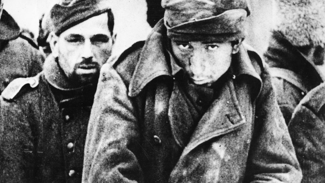 German prisoners and soldiers from other Axis countries huddle against the sharp winds of the Russian winter in  February 1943 after the defeat of the German Army at Stalingrad.