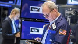 In this photo provided by the New York Stock Exchange, trader David O'Day, right, works on the floor, Thursday, March 31, 2022.