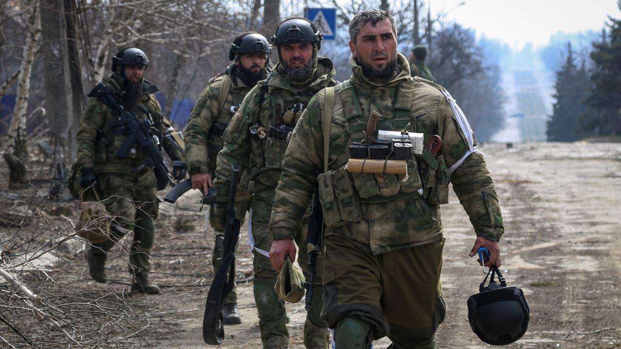 Service members from the Chechen Republic walk during fighting in the Ukraine-Russia conflict in the city of Mariupol on March 31, 2022.