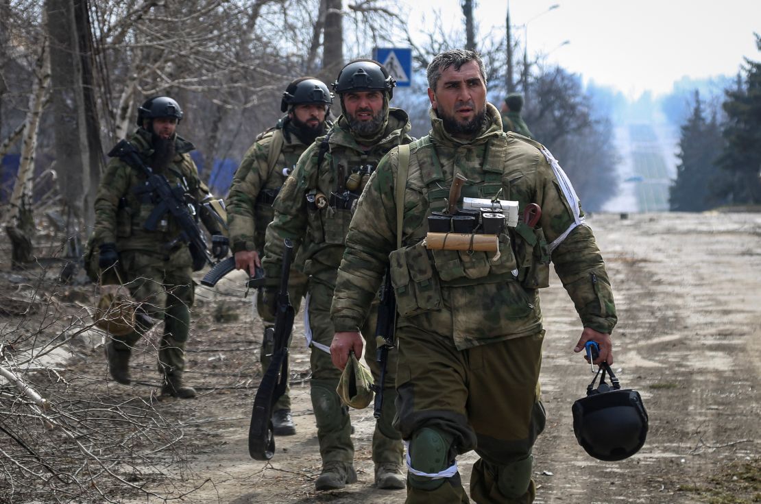 Service members from the Chechen Republic walk during fighting in the Ukraine-Russia conflict in the city of Mariupol on March 31, 2022. 