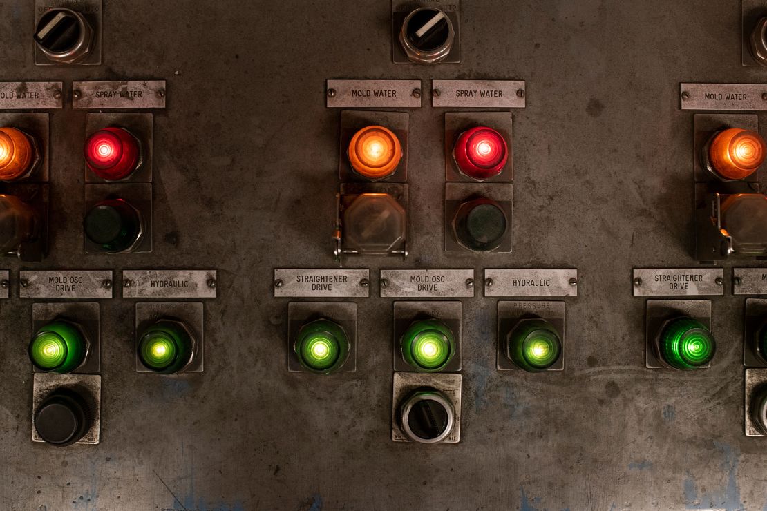 Buttons are illuminated on a panel in a control room at the Pueblo steel mill on March 29.