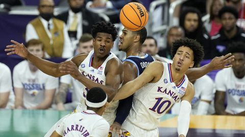 Villanova forward Eric Dixon, center, collides with Kansas forward Jalen Wilson (10) under the hoop during the semifinal round of the Men's Final Four NCAA tournament Saturday in New Orleans.