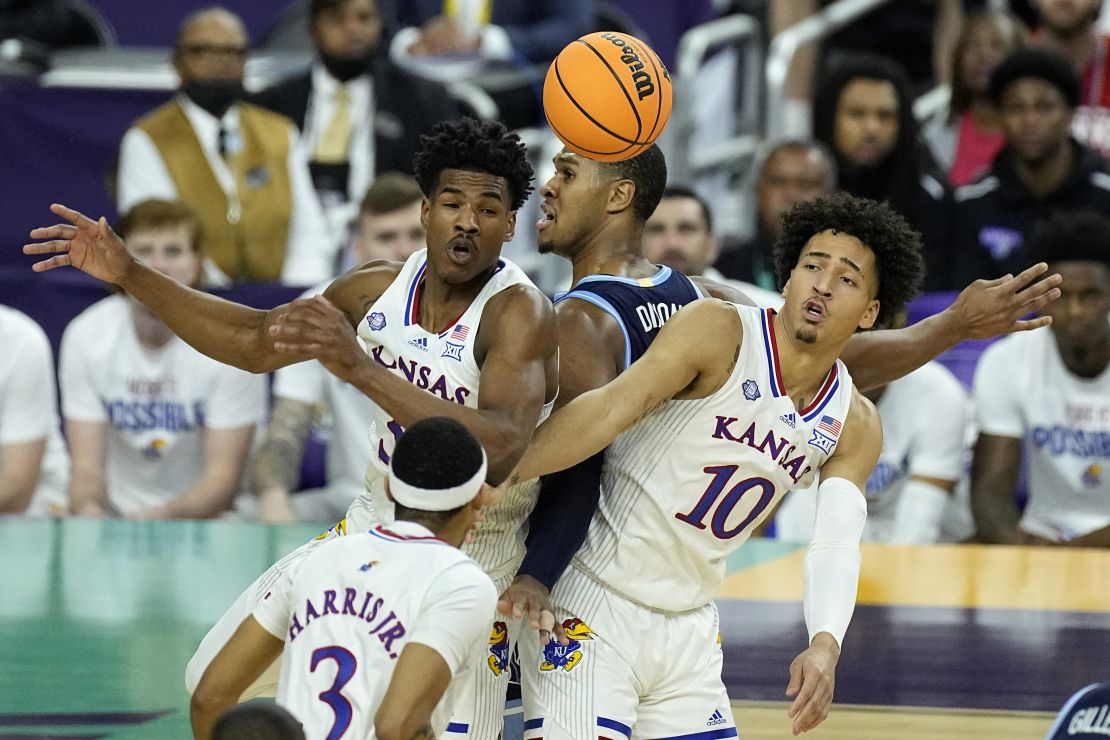 Villanova forward Eric Dixon, center, collides with Kansas forward Jalen Wilson (10) under the hoop during the semifinal round of the Men's Final Four NCAA tournament Saturday in New Orleans.
