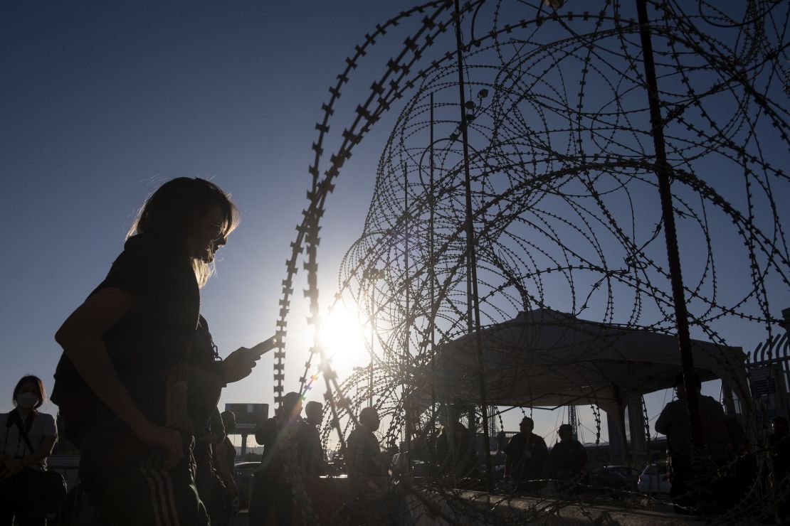 A 21-year-old asylum seeker from Ukraine waits with others from her country for US border authorities to allow them in on the Mexican side of the San Ysidro Crossing port in Tijuana, Baja California state, Mexico, on March 24, 2022.
