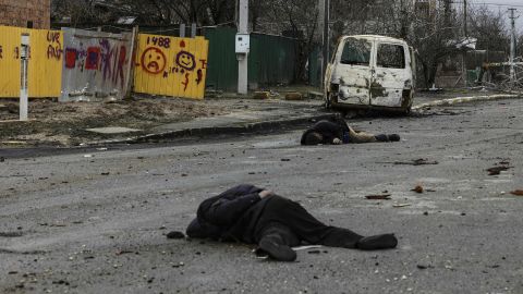 Bodies lie in a street in Bucha on Saturday. A portion of this photo has been blurred to protect the victim's identity. 