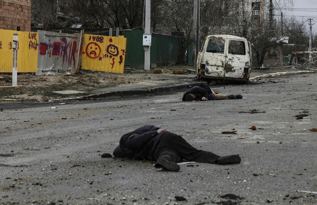 Bodies lie in a street in Bucha on Saturday. A portion of this photo has been blurred to protect the victim's identity. 