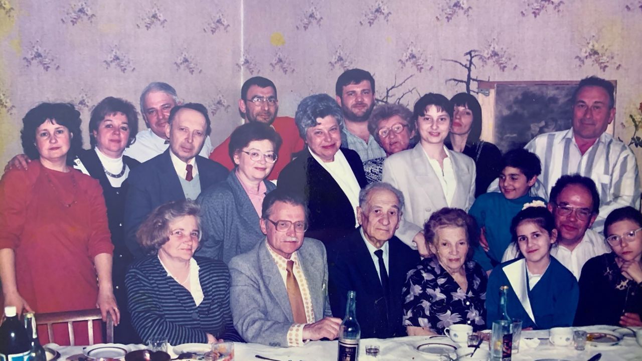 A photo taken about 25 years ago shows Margaryta Zatuchna with her family. She is pictured fourth from left in the second row, wearing glasses and a pink blouse. To her right is her late husband Valerii.