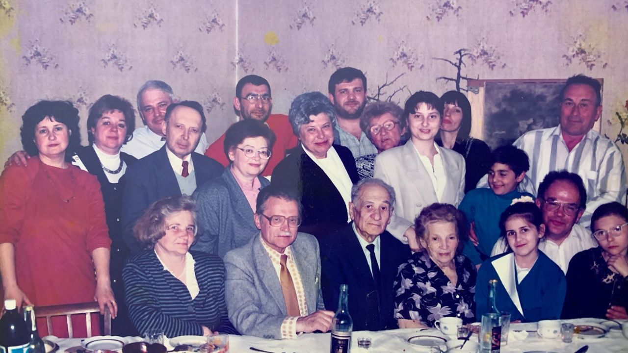 A photo taken about 25 years ago shows Margaryta Zatuchna with her family. She is pictured fourth from left in the second row, wearing glasses and a pink blouse. To her right is her late husband Valerii.