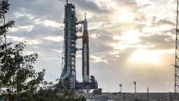 Blue sky and clouds serve as the backdrop for a sunrise view of the Artemis I Space Launch System (SLS) and Orion spacecraft at Launch Pad 39B at NASA's Kennedy Space Center in Florida on March 23, 2022. 