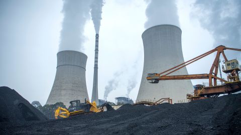 A bulldozer pushes coal onto a conveyor belt at the Jiangyou Power Station in Jiangyou, Mianyang City, Sichuan Province of China.