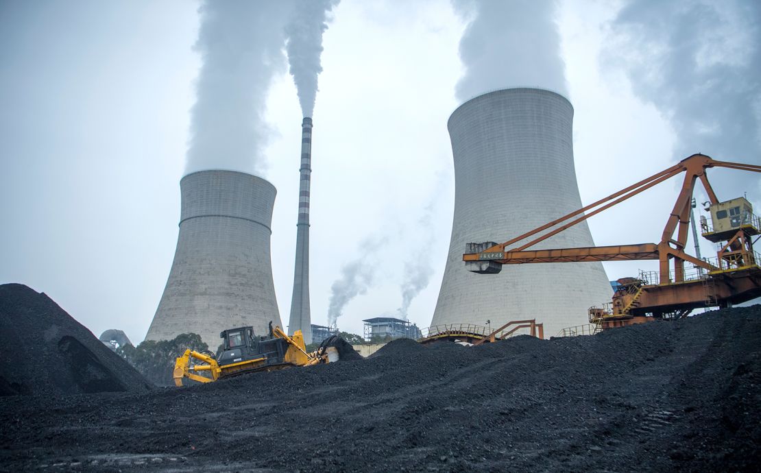 A bulldozer pushes coal onto a conveyor belt at the Jiangyou Power Station in Jiangyou, Mianyang City, Sichuan Province of China.