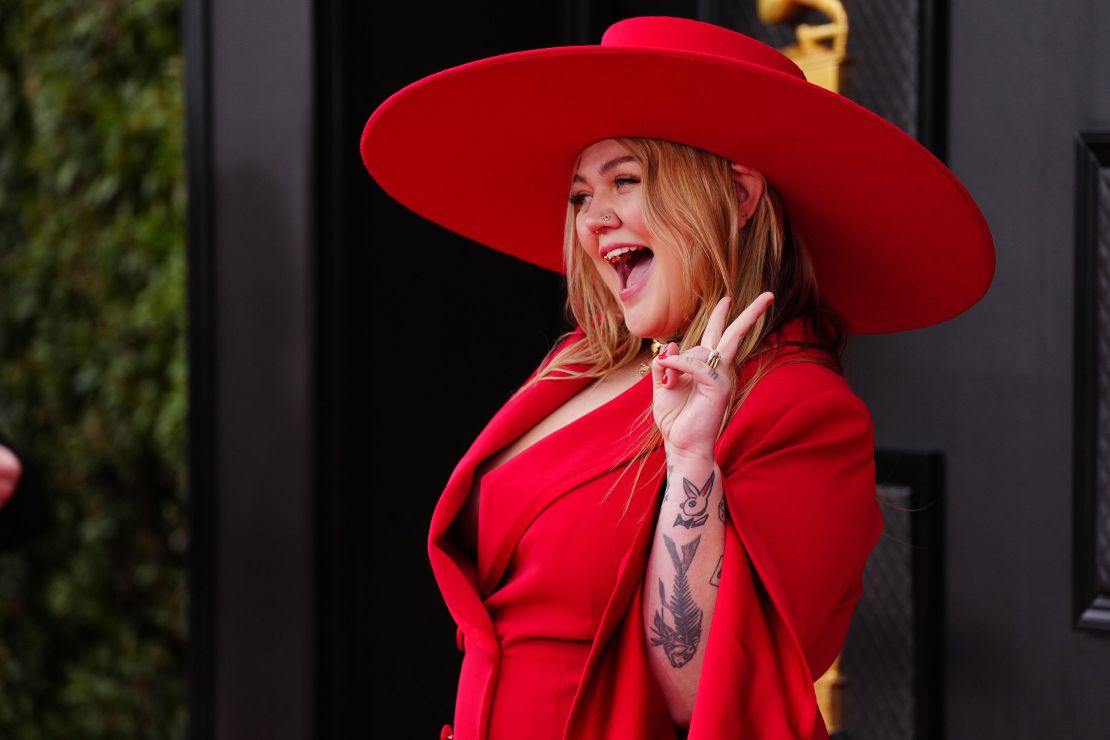 Country star Elle King wore a wide-brimmed hat with a matching red pantsuit by designer Christian Siriano. 