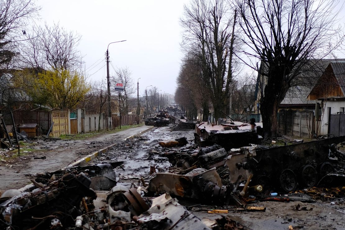 A column of Russian armored vehicles litters a road in Bucha.