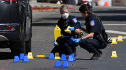 Sacramento Police crime scene investigators place evidence markers on 10th street at the scene of a mass shooting in Sacramento, Calif., on Sunday, April 3, 2022.  (Jose Carlos Fajardo/Bay Area News Group via AP)