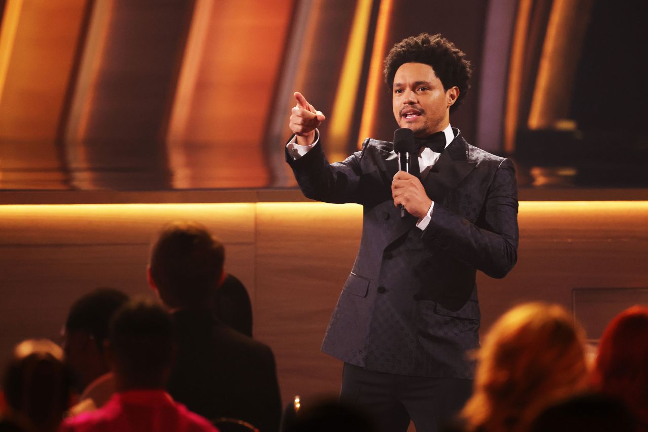 Host Trevor Noah delivers the show's opening monologue. Noah, who also hosted the show last year, referenced <a href="http://www.cnn.com/2022/03/27/entertainment/gallery/2022-academy-awards-photos/index.html" target="_blank">last week's Oscars moment</a> when Will Smith slapped Chris Rock. "We're going to be dancing. We're going to be singing. We're going to be keeping people's names out of our mouths," Noah joked.