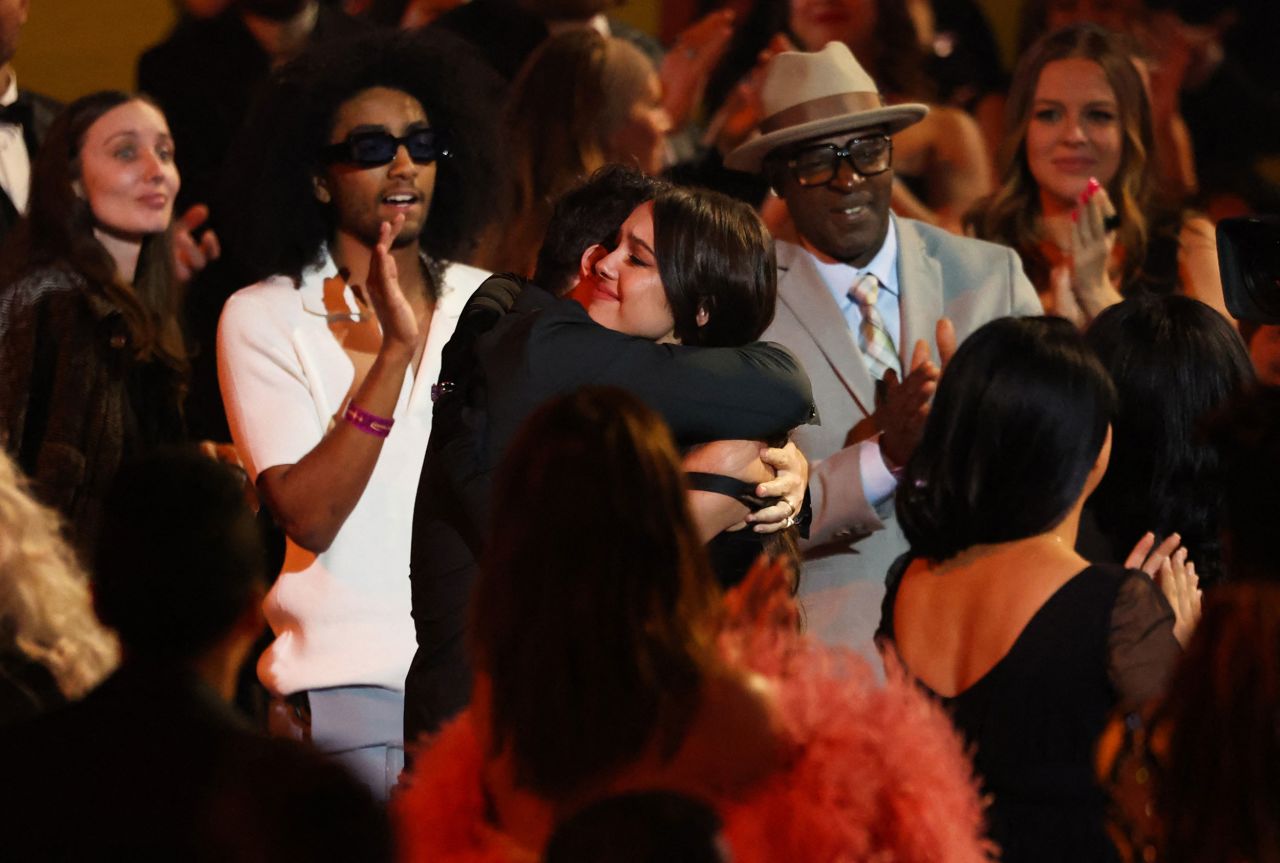 Olivia Rodrigo gets a hug after winning the Grammy for best new artist.