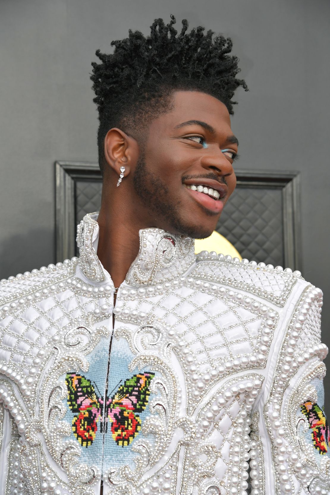 A close up of a butterfly design on Lil Nas X's Grammys outfit. 