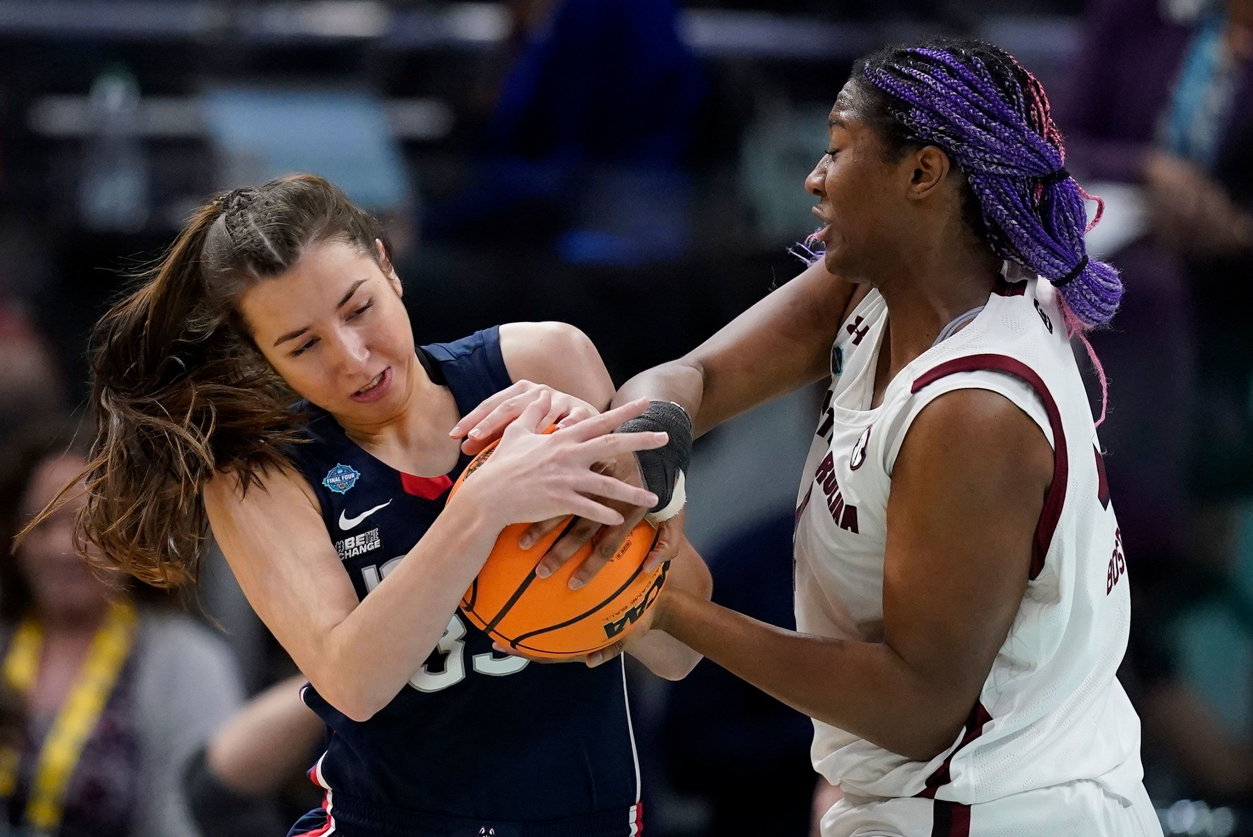 Boston and UConn's Caroline Ducharme wrestle for the ball.