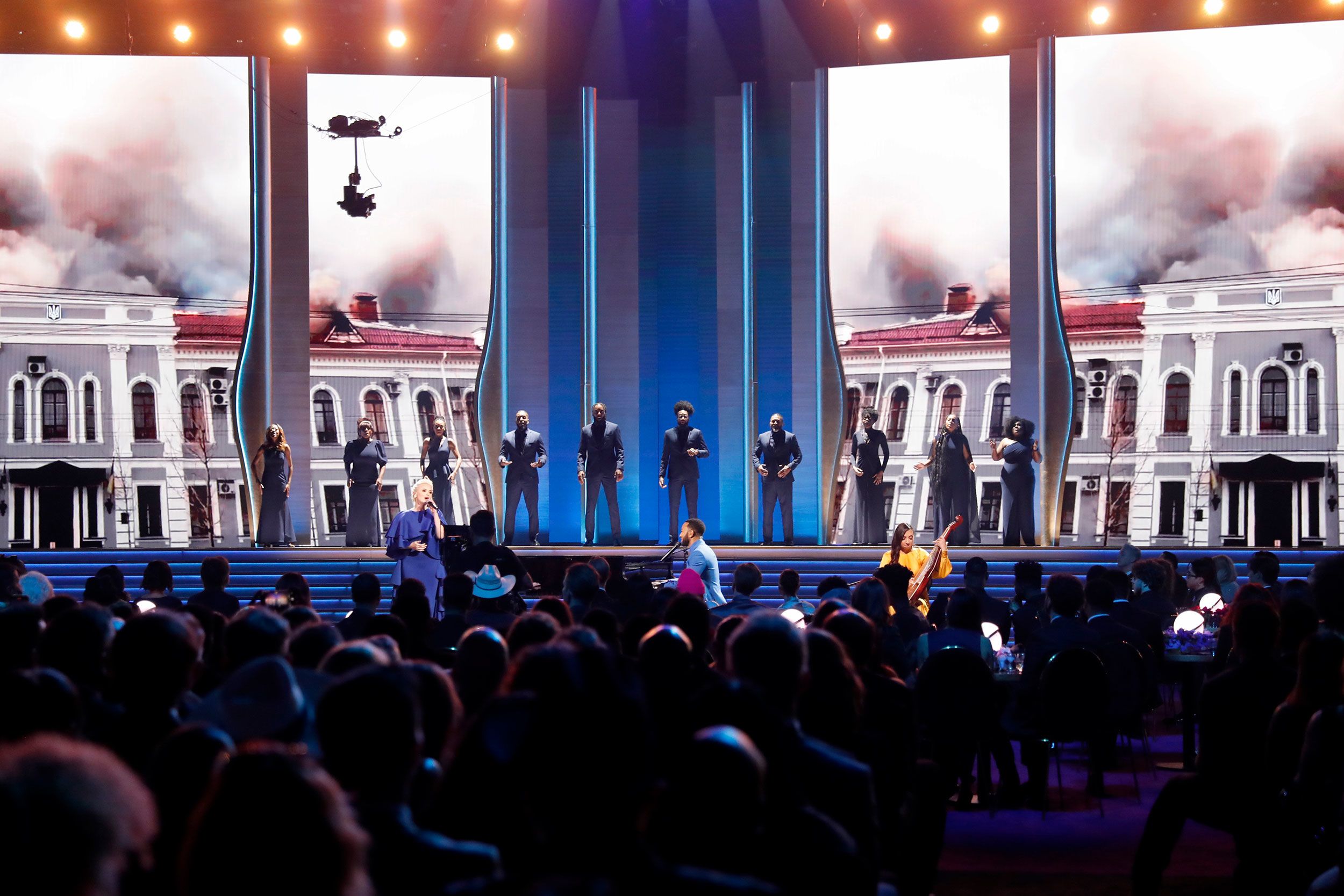 John Legend performs his song "Free" with Ukrainian singer Mika Newton, left, and Ukrainian-American musician Siuzanna Iglidan.