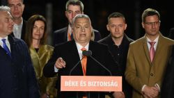 Hungarian Prime Minister Viktor Orban delivers a speech on stage next to members of the Fidesz party at their election base, 'Balna' building on the bank of the Danube River of Budapest, on April 3, 2022. - Nationalist Hungarian Prime Minister Viktor Orban claimed a "great victory" in general election, as partial results gave his Fidesz party the lead. (Photo by Attila KISBENEDEK / AFP) (Photo by ATTILA KISBENEDEK/AFP via Getty Images)
