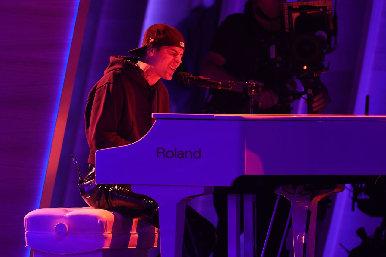 Justin Bieber plays the piano while performing his song "Peaches."