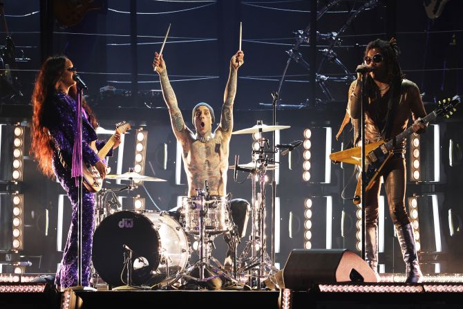 From left, H.E.R., Travis Barker and Lenny Kravitz perform together.