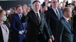 GRUENHEIDE, GERMANY - MARCH 22: German Chancellor Olaf Scholz (R), Brandenburg State Premier Dietmar Woidke (2ndR) and Tesla CEO Elon Musk (C) attend the official opening of the new Tesla electric car manufacturing plant on March 22, 2022 near Gruenheide, Germany. The new plant, officially called the Gigafactory Berlin-Brandenburg, is producing the Model Y as well as electric car batteries. 