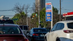 Cars drive past an Exxon gas station on April 01, 2022 in Houston, Texas. 