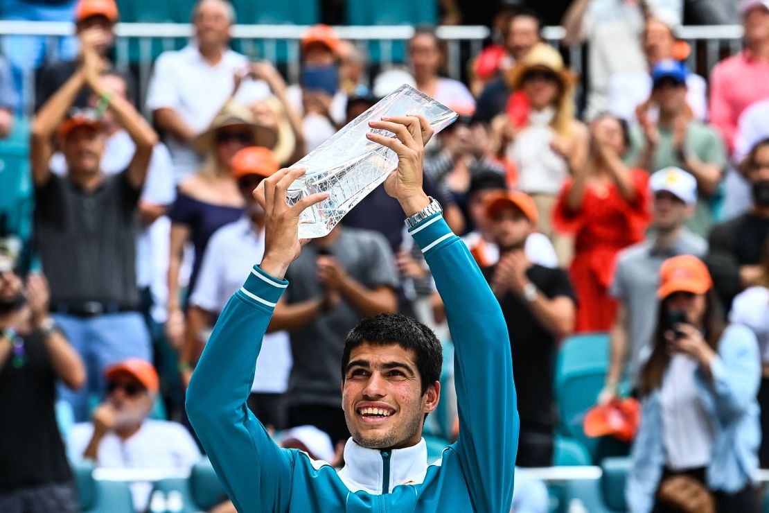 Alcaraz poses with his first Masters 1000 trophy after winning the Miami Open.